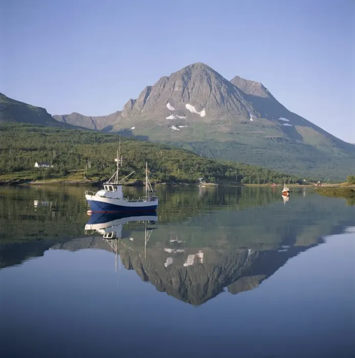 Framed Print : Boat and mountains reflected in tranquil water Framed Print : Boat and mountains reflected in tranquil water
