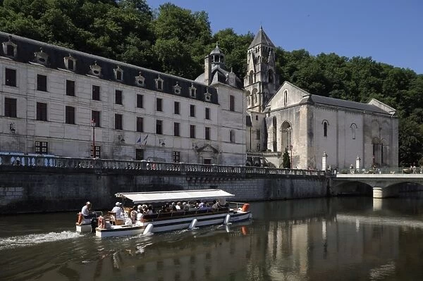 Boat passing in front of the Abbey, Brantome. Dordogne, France. Europe