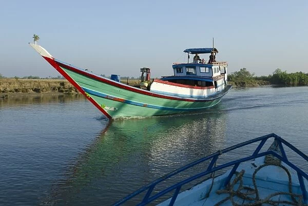 Boat on waterway in the Irrawaddy delta, Myanmar (Burma), Asia