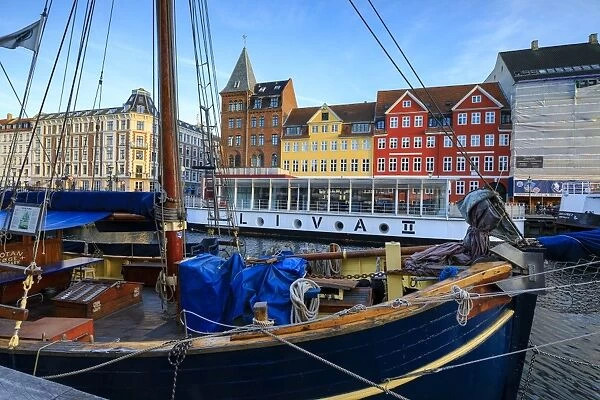 Boats in Christianshavn Canal with typical colourful houses in the background, Copenhagen