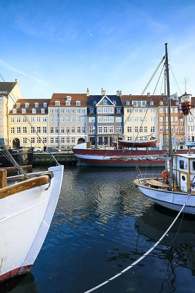 Boats in Christianshavn Canal with typical colourful houses in the background, Copenhagen