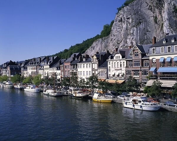 Boats line the waterfront on the River Meuse in the old town of Dinant in the Ardennes