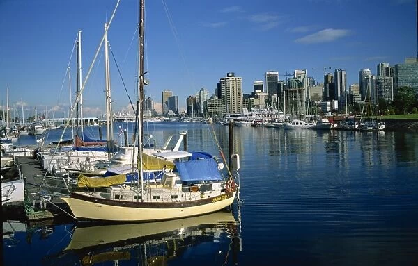 Boats in the marina at Stanley Park with the city skyline of Vancouver behind