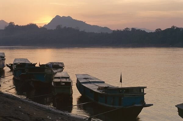Boats on the Mekong River at sunset