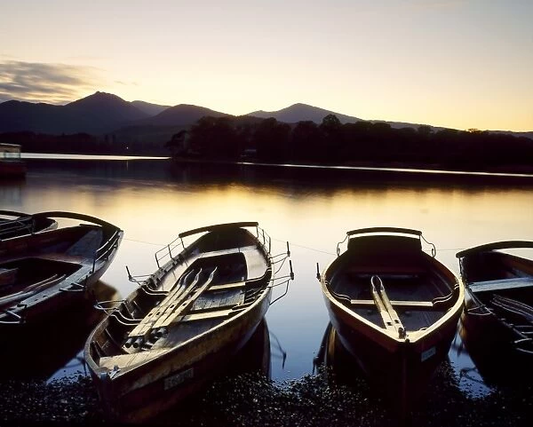 Boats moored beside Derwent Water at dusk, Lake District, Cumbria, England
