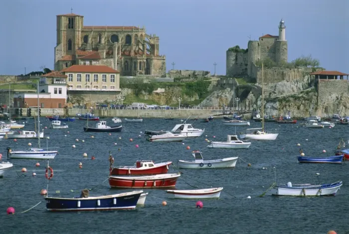 Framed Print : Boats moored in harbour and the 12th century church of Santa Maria Framed Print : Boats moored in harbour and the 12th century church of Santa Maria