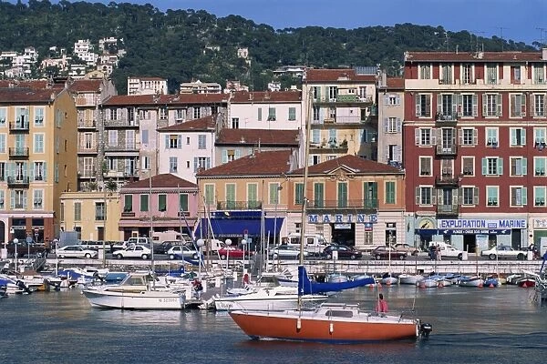Boats moored in the harbour and houses on waterfront, Nice, Alpes Maritimes