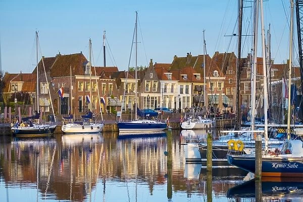 Boats moored in front of historic buildings along the Oude Haven (Old Harbor), Enkhuizen