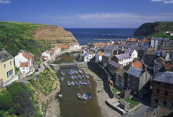 Boats moored in the protected harbour of Staithes, Yorkshire, England, United Kingdom