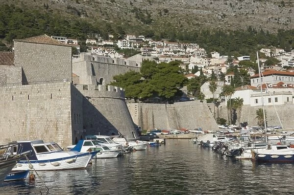 Boats moored in the shelter of the walls of the Old City, Dubrovnik, UNESCO World Heritage Site, Croatia, Europe