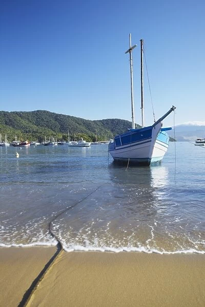 Boats moored on Vila do Abraao beach, Ilha Grande, Rio de Janeiro State, Brazil, South America