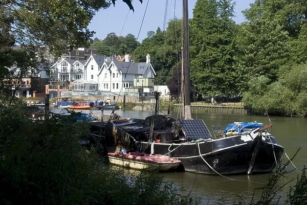 Boats, one with a solar panel, moored on the Thames at Richmond, Surrey