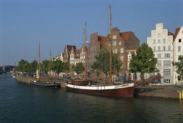 Boats with tall masts on the waterfront of Lubeck City