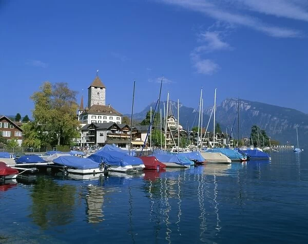 Boats on the water and the town of Spiez on Lake Thunersee in the Bernese Oberland