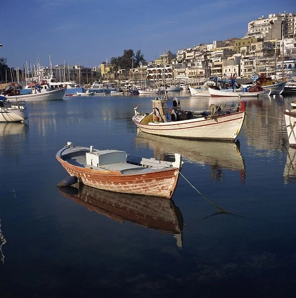 Boats in the yacht harbour and the town of Piraeus in the background