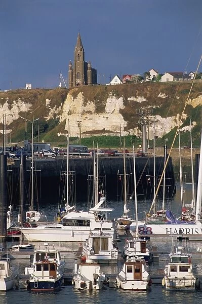 Boats and yachts in the harbour and church on skyline above cliffs, Dieppe