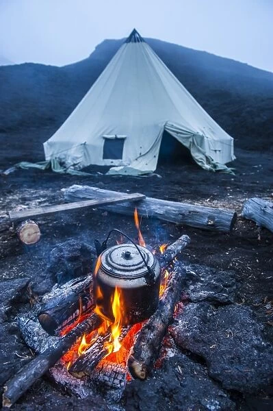 Boiling water pot over an open fire on a campsite and tipi on Tolbachik volcano, Kamchatka, Russia, Eurasia