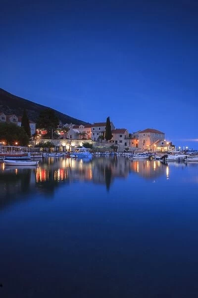 Bol Harbour lit up at dusk, Bol, Brac Island, Dalmatian Coast, Croatia, Europe