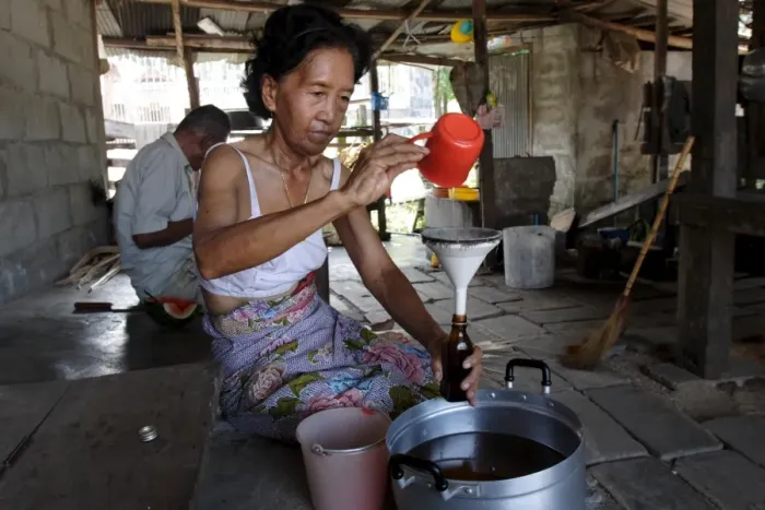 Framed Print : Bottling coconut oil to sell Framed Print : Bottling coconut oil to sell