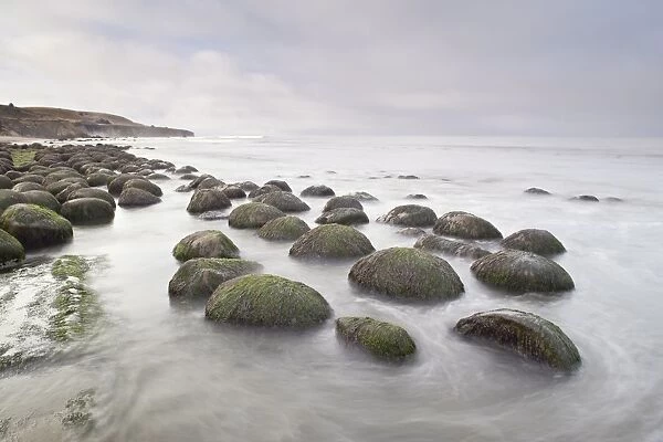 Boulders, known as Bowling Ballls, in the surf, Bowling Ball Beach, California