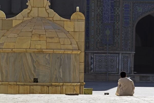 Boy praying in courtyard of Friday Mosque (Masjet-e Jam) (Masjid-e Jam) (Masjid-I-Jami)