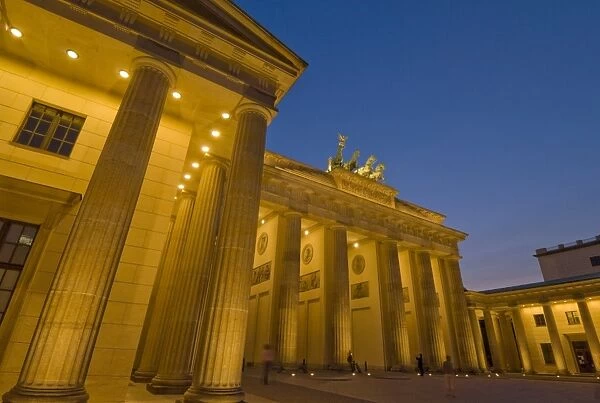 The Brandenburg Gate with the Quadriga winged victory statue on top, illuminated at night