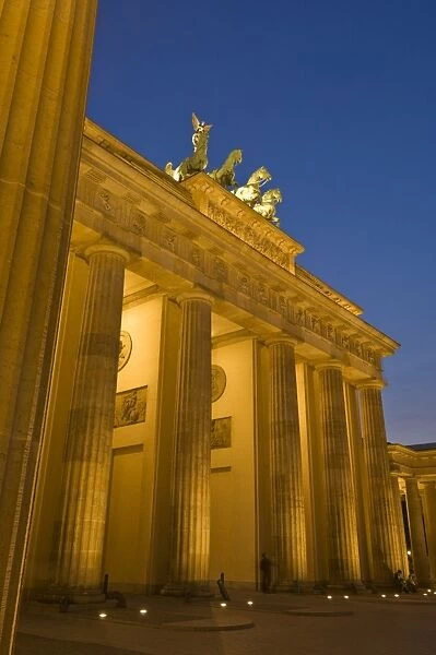The Brandenburg Gate with the Quadriga winged victory statue on top illuminated at night