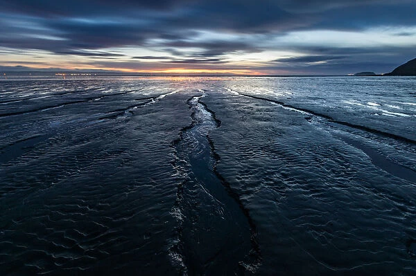 Brean Beach, mud and the Bristol Channel at sunset, Somerset, England, United Kingdom