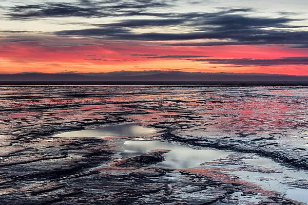 Brean Beach at sunset, mud and the Bristol Channel, Somerset, England, United Kingdom