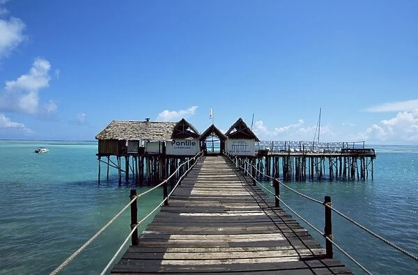 Bridge leading to a bar on the water, Kiwengwa beach, Zanzibar, Tanzania