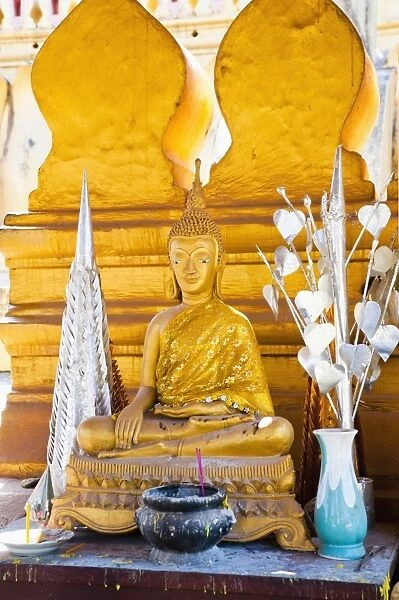 Bright gold Buddha statue at Pha That Luang, a Buddhist templ, Vientiane, Laos, Indochina, Southeast Asia, Asia