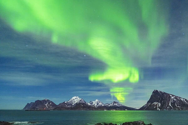Bright green lights of Aurora Borealis (Northern Lights) reflecting in the sea, Myrland, Leknes, Vestvagoy, Lofoten Islands, Norway, Scandinavia, Europe