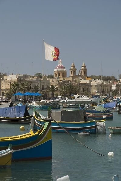 Brightly coloured fishing boats called Luzzus at the fishing village of Marsaxlokk