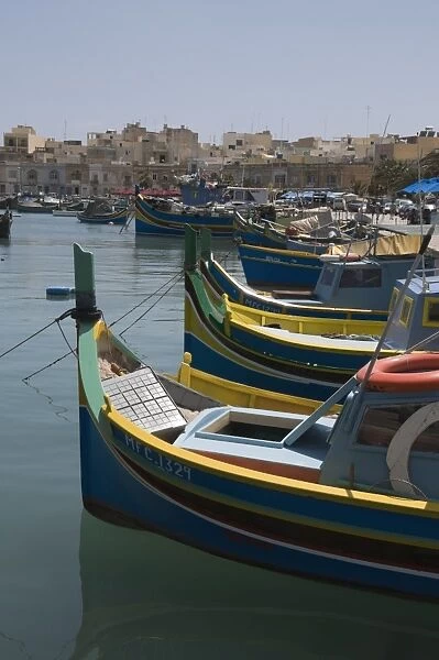 Brightly coloured fishing boats called Luzzus at the fishing village of Marsaxlokk