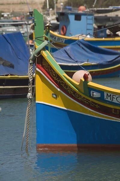 Brightly coloured fishing boats called Luzzus with the eye of Osiris to ward off evil at Marsaxlokk