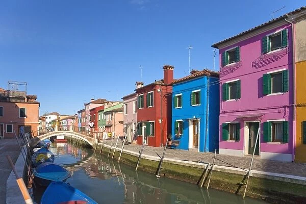 Brightly coloured houses along canal in Burano town, Venice Lagoon Island
