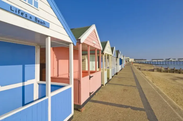 Framed Print : Brightly painted beach huts in the afternoon sunshine, on the seafront promenade Framed Print : Brightly painted beach huts in the afternoon sunshine, on the seafront promenade