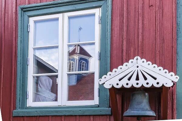 Brightly painted house reflected in window in Sisimiut, Greenland, Polar Regions curve adjustments, boosted bluish shadows and rediish highlights