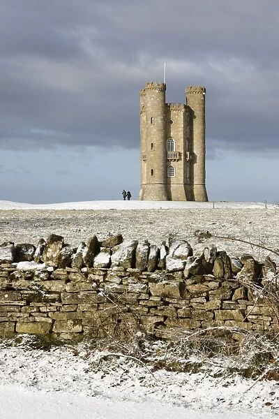 Broadway Tower and Cotswold drystone wall in snow, Broadway, Cotswolds, Worcestershire