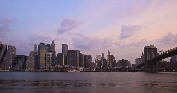Brooklyn Bridge spanning the East River and the Lower Manhattan skyline at dawn