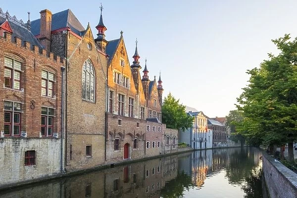 Brugse Vrije and buildings along the Groenerei canal at dusk, Bruges (Brugge), West Flanders