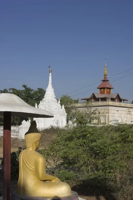 Framed Print : Buddha image sitting under parasol near pagodas, Salay, Myanmar (Burma), Asia Framed Print : Buddha image sitting under parasol near pagodas, Salay, Myanmar (Burma), Asia