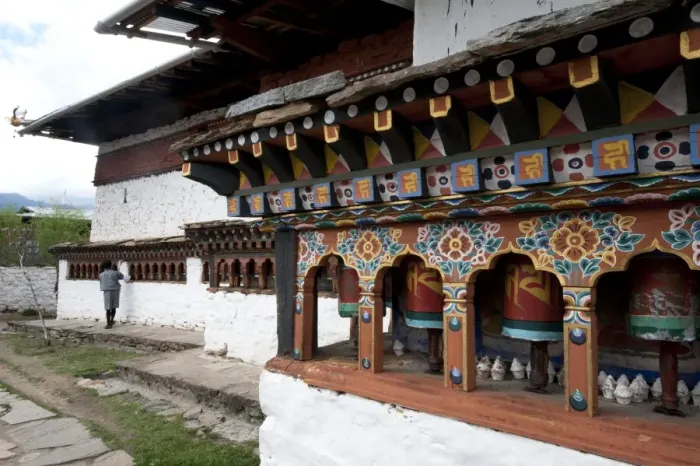 Framed Print : Buddhist man spinning temple prayer wheels outside Dumtse Lakhang Buddhist temple Framed Print : Buddhist man spinning temple prayer wheels outside Dumtse Lakhang Buddhist temple