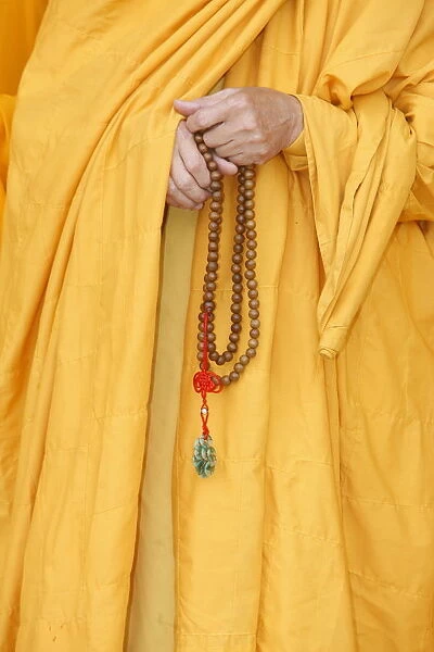 Buddhist monk holding prayer beads, Thiais, Val de Marne, France, Europe