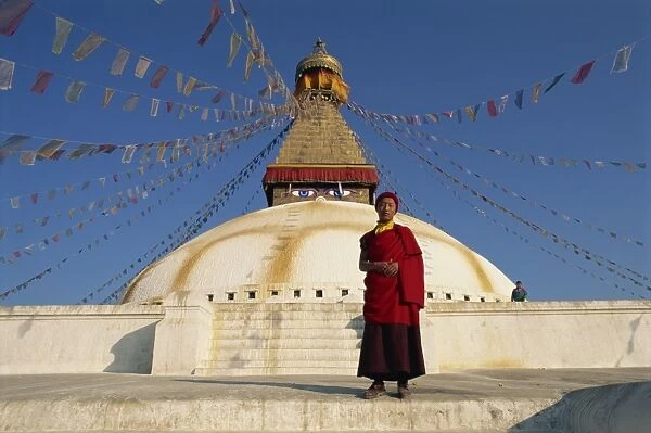 Buddhist monk in front of the largest stupa in Nepal