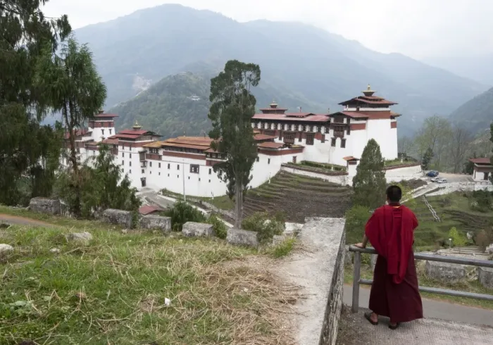 Framed Print : Buddhist monk looking back at Trongsa Dzong, Bhutans largest monastery fortress Framed Print : Buddhist monk looking back at Trongsa Dzong, Bhutans largest monastery fortress