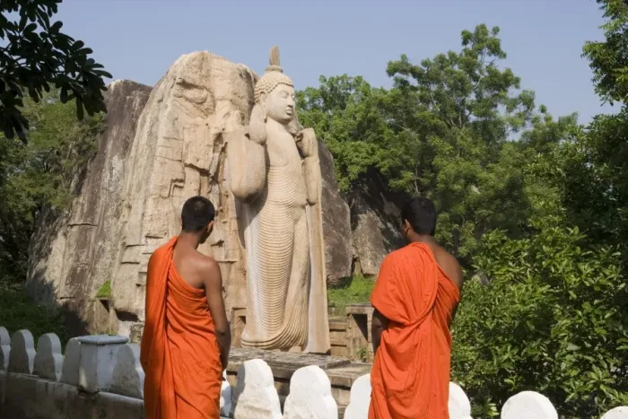 Framed Print : Buddhist monks in front of the giant standing statue