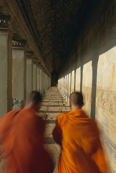 Buddhist monks in passageway, Angkor Wat, UNESCO World Heritage Site, Siem Reap