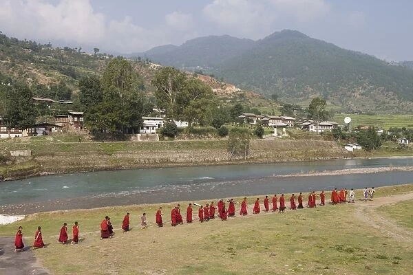 Buddhist monks from Punakha Dzong going to the river to meditate, Punakha, Bhutan, Asia
