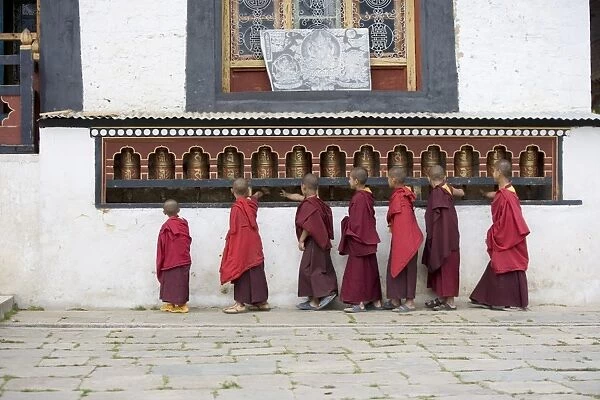 Buddhist monks turning prayer wheels, Karchu Dratsang Monastery, Jankar